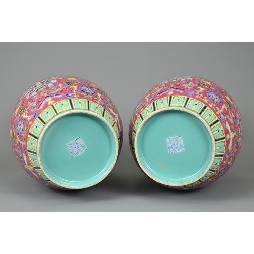 28 - A PAIR OF CHINESE RUBY GROUND PORCELAIN VASES, DAOGUANG MARK. Decorated in famille rose enamels with... 