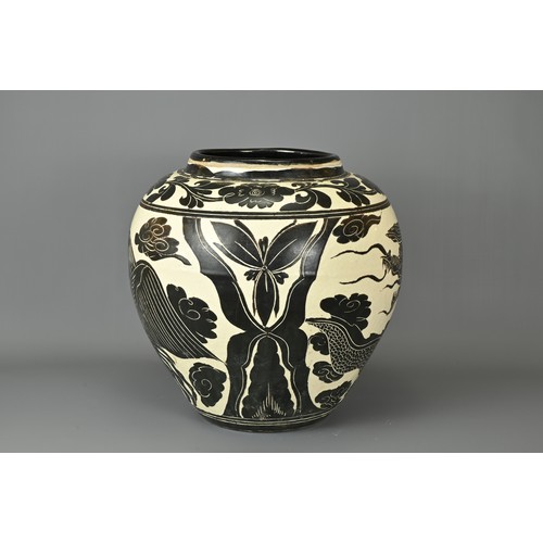 62 - A LARGE CHINESE CIZHOU TYPE DRAGON AND PHOENIX JAR. Sgraffito decorated black and cream coloured gla... 