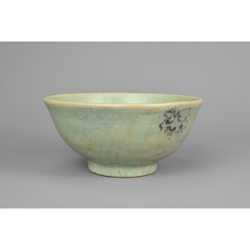 108 - A CHINESE CELADON BOWL, YUAN/MING DYNASTY. Rounded body with short foot and carved floral decoration... 