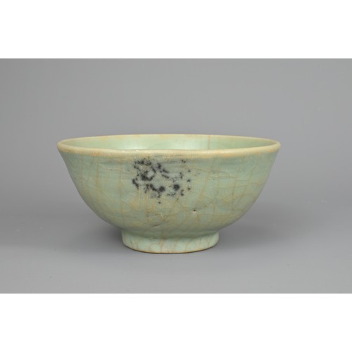 108 - A CHINESE CELADON BOWL, YUAN/MING DYNASTY. Rounded body with short foot and carved floral decoration... 