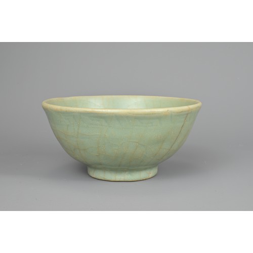 108 - A CHINESE CELADON BOWL, YUAN/MING DYNASTY. Rounded body with short foot and carved floral decoration... 