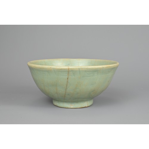 108 - A CHINESE CELADON BOWL, YUAN/MING DYNASTY. Rounded body with short foot and carved floral decoration... 