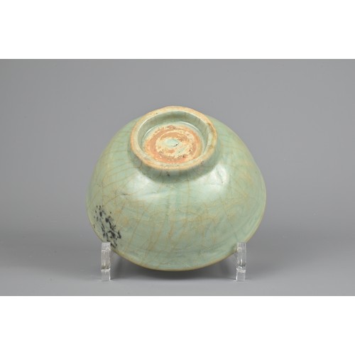 108 - A CHINESE CELADON BOWL, YUAN/MING DYNASTY. Rounded body with short foot and carved floral decoration... 