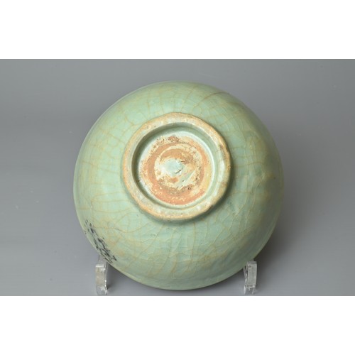 108 - A CHINESE CELADON BOWL, YUAN/MING DYNASTY. Rounded body with short foot and carved floral decoration... 