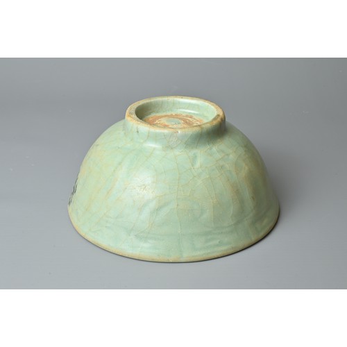 108 - A CHINESE CELADON BOWL, YUAN/MING DYNASTY. Rounded body with short foot and carved floral decoration... 