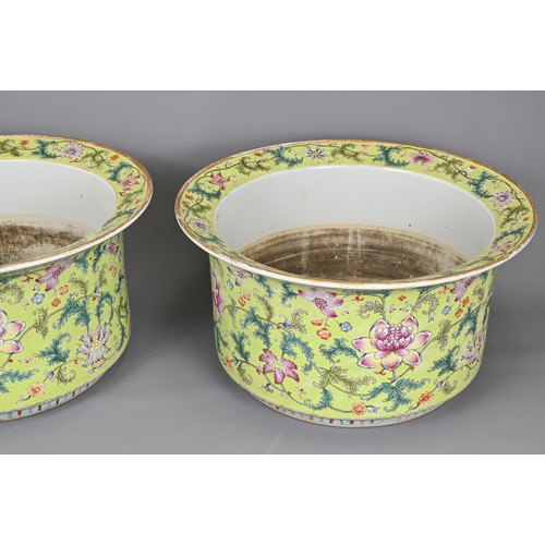 89 - A LARGE PAIR OF CHINESE LIME GREEN GROUND FAMILLE ROSE PORCELAIN JARDINIERES. Of cylindrical form wi... 