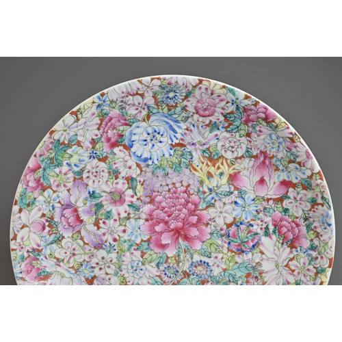 9 - A CHINESE FAMILLE ROSE MILLEFLEURS PORCELAIN DISH, EARLY 20TH CENTURY. Densely decorated with enamel... 