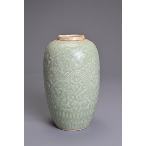 35 - A CHINESE PALE CELADON PORCELAIN JAR, 19TH CENTURY. Of ovoid form with moulded decoration of two opp... 