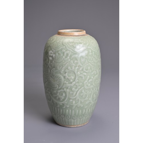 35 - A CHINESE PALE CELADON PORCELAIN JAR, 19TH CENTURY. Of ovoid form with moulded decoration of two opp... 