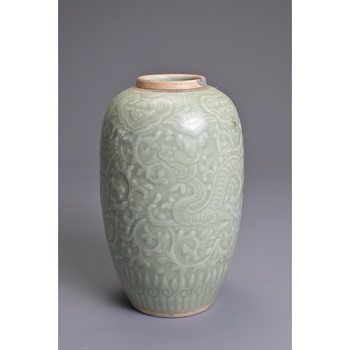 35 - A CHINESE PALE CELADON PORCELAIN JAR, 19TH CENTURY. Of ovoid form with moulded decoration of two opp... 