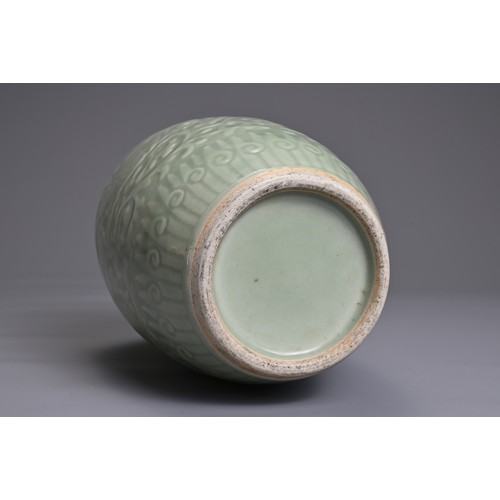 35 - A CHINESE PALE CELADON PORCELAIN JAR, 19TH CENTURY. Of ovoid form with moulded decoration of two opp... 