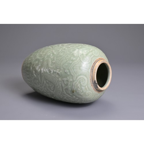 35 - A CHINESE PALE CELADON PORCELAIN JAR, 19TH CENTURY. Of ovoid form with moulded decoration of two opp... 