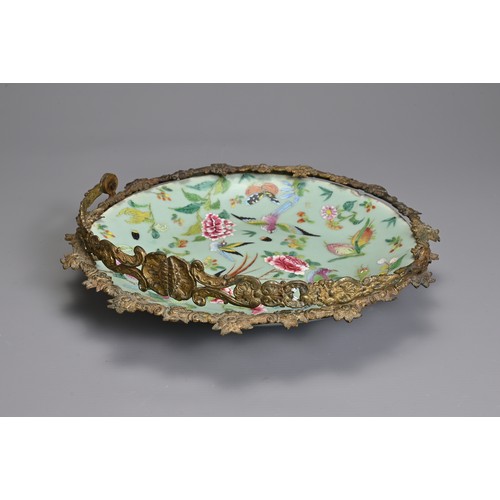 36 - A MOUNTED CHINESE CELADON GROUND FAMILLE ROSE DISH, 19TH CENTURY. The dish decorated with birds, but... 