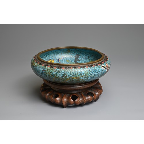 54 - A CHINESE CLOISONNE ENAMEL BOWL WITH WOODEN STAND, 19/20TH CENTURY. With rounded sides decorated wit... 