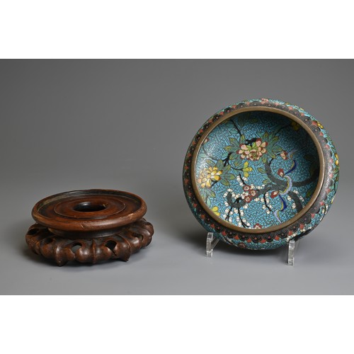 54 - A CHINESE CLOISONNE ENAMEL BOWL WITH WOODEN STAND, 19/20TH CENTURY. With rounded sides decorated wit... 