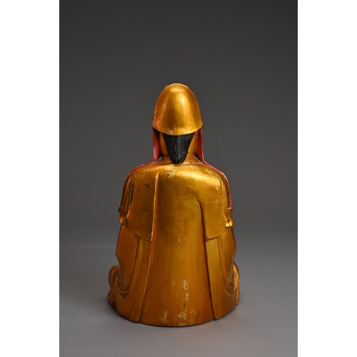 61 - A CHINESE RED LACQUER AND GILT WOOD FIGURE OF GUANYIN. The figure seated in dhyanasana dressed in fl... 