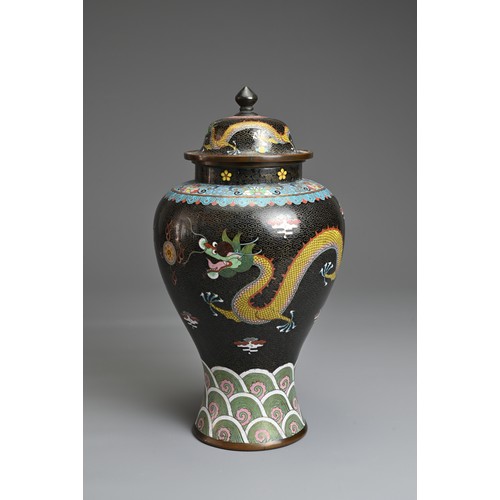 70 - A CHINESE CLOISONNE ENAMEL VASE AND COVER, EARLY 20TH CENTURY. Black ground with dragons chasing fla... 