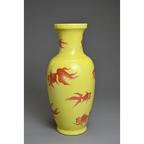 76 - A CHINESE YELLOW GROUND PORCELAIN GOLDFISH VASE, 20TH CENTURY. Of baluster form decorated with iron-... 