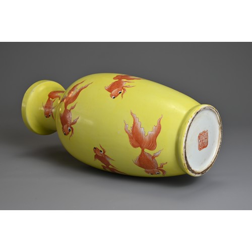 76 - A CHINESE YELLOW GROUND PORCELAIN GOLDFISH VASE, 20TH CENTURY. Of baluster form decorated with iron-... 