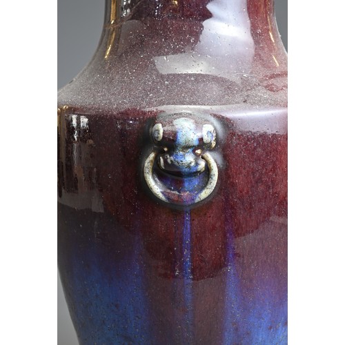 77 - A LARGE CHINESE FLAMBE GLAZED PORCELAIN VASE, 18/19TH CENTURY. Of baluster form with lion mask ring ... 