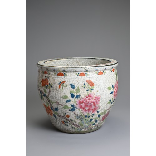 81 - A CHINESE CRACKLE GLAZED PORCELAIN JARDINIERE, 19TH CENTURY. Famille rose enamelled decoration of bu... 