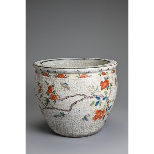 81 - A CHINESE CRACKLE GLAZED PORCELAIN JARDINIERE, 19TH CENTURY. Famille rose enamelled decoration of bu... 