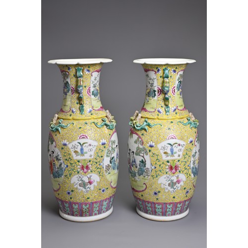 86 - A PAIR OF CHINESE YELLOW GROUND FAMILLE ROSE PORCELAIN VASES, EARLY 20TH CENTURY. Each of baluster f... 