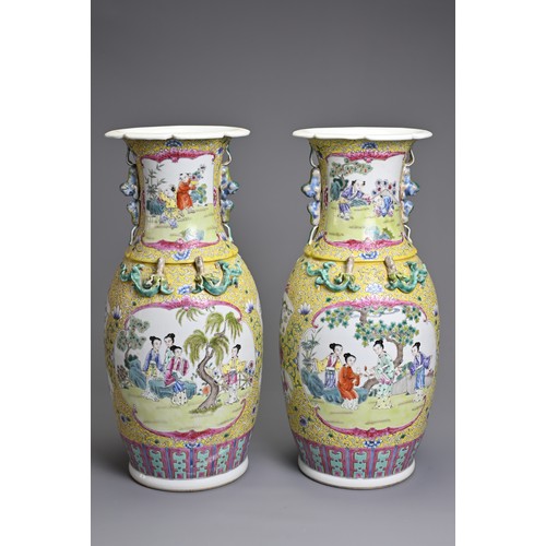 86 - A PAIR OF CHINESE YELLOW GROUND FAMILLE ROSE PORCELAIN VASES, EARLY 20TH CENTURY. Each of baluster f... 