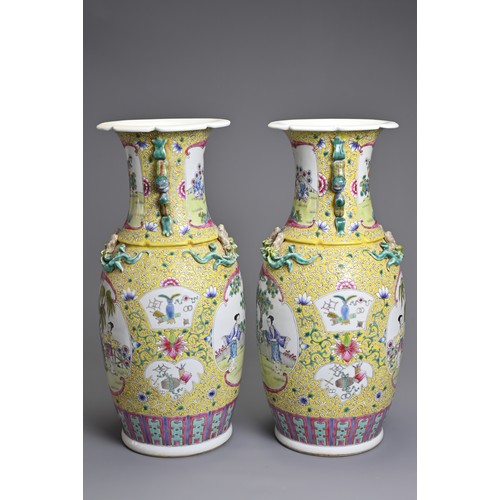 86 - A PAIR OF CHINESE YELLOW GROUND FAMILLE ROSE PORCELAIN VASES, EARLY 20TH CENTURY. Each of baluster f... 