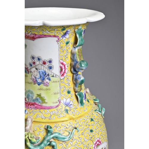 86 - A PAIR OF CHINESE YELLOW GROUND FAMILLE ROSE PORCELAIN VASES, EARLY 20TH CENTURY. Each of baluster f... 