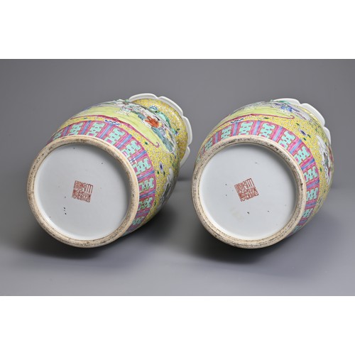 86 - A PAIR OF CHINESE YELLOW GROUND FAMILLE ROSE PORCELAIN VASES, EARLY 20TH CENTURY. Each of baluster f... 