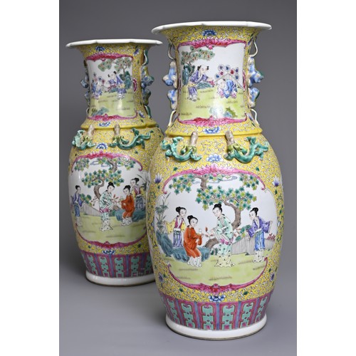 86 - A PAIR OF CHINESE YELLOW GROUND FAMILLE ROSE PORCELAIN VASES, EARLY 20TH CENTURY. Each of baluster f... 