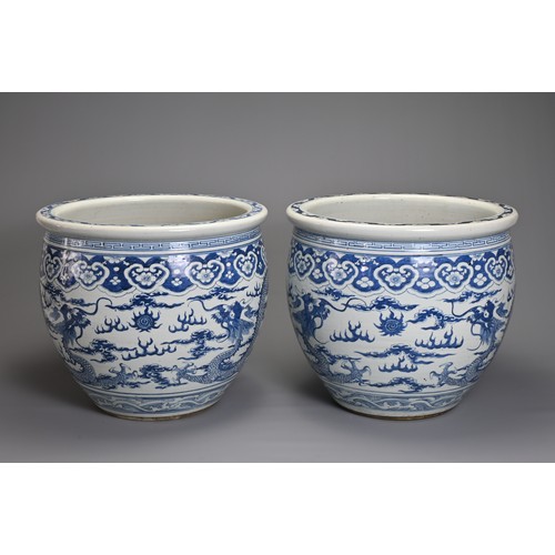 90 - A GOOD LARGE PAIR OF CHINESE BLUE AND WHITE PORCELAIN JARDINIERS, 19TH CENTURY. Heavily potted, deco... 