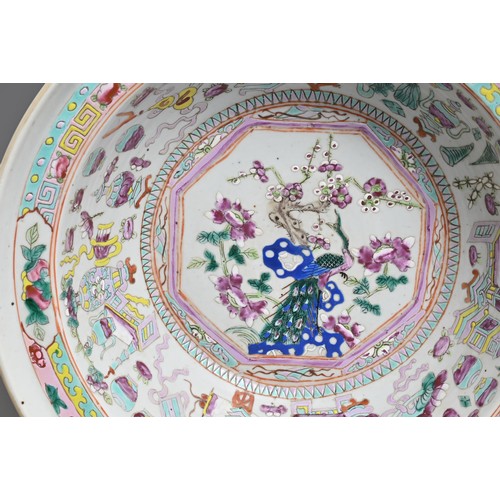 91 - A LARGE CHINESE FAMILLE ROSE ENAMELLED PORCELAIN BASIN, 19TH CENTURY. Rounded sides with a stepped r... 