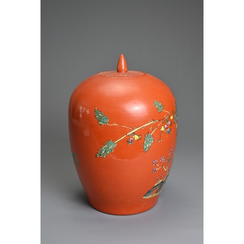 97 - A CHINESE CORAL GROUND PORCELAIN JAR AND COVER, 20TH CENTURY. Of ovoid form decorated with fruit tre... 