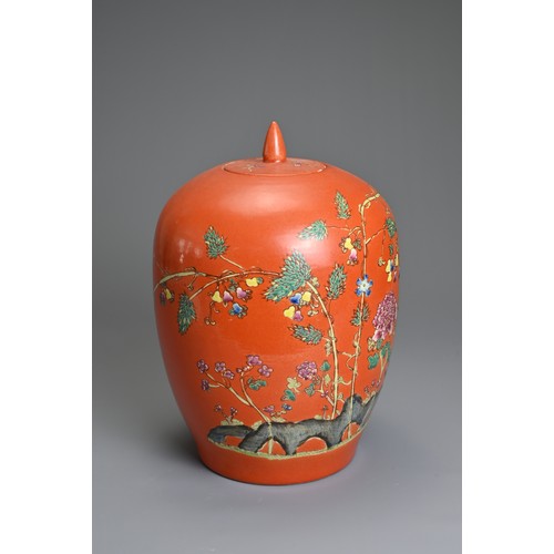 97 - A CHINESE CORAL GROUND PORCELAIN JAR AND COVER, 20TH CENTURY. Of ovoid form decorated with fruit tre... 