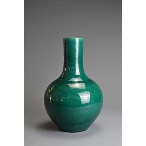 54 - A CHINESE MONOCHROME GREEN GLAZED PORCELAIN BOTTLE VASE, 20TH CENTURY. Globular body with cylindrica... 