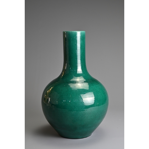 54 - A CHINESE MONOCHROME GREEN GLAZED PORCELAIN BOTTLE VASE, 20TH CENTURY. Globular body with cylindrica... 