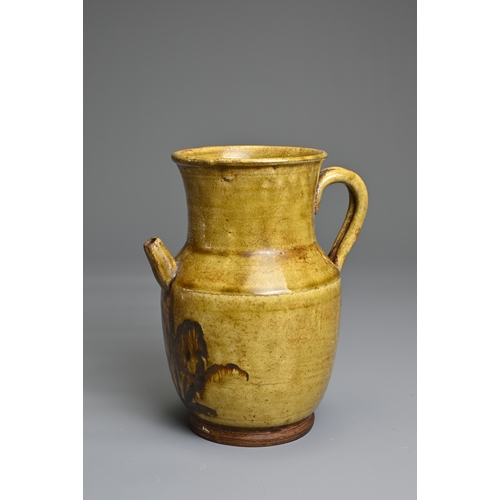 73 - A CHANGSHA TYPE GLAZED STONEWARE EWER COATED IN A FINELY CRACKLED YELLOWISH GREEN GLAZE. Below the s... 