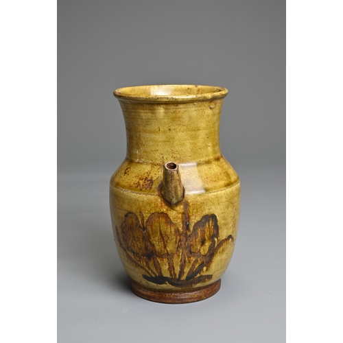 73 - A CHANGSHA TYPE GLAZED STONEWARE EWER COATED IN A FINELY CRACKLED YELLOWISH GREEN GLAZE. Below the s... 