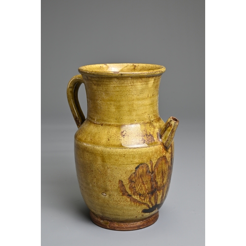 73 - A CHANGSHA TYPE GLAZED STONEWARE EWER COATED IN A FINELY CRACKLED YELLOWISH GREEN GLAZE. Below the s... 