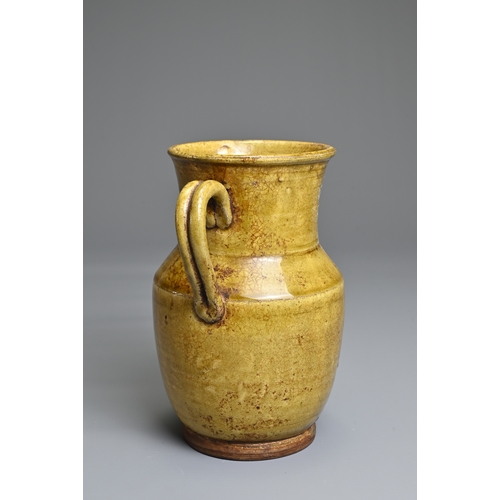 73 - A CHANGSHA TYPE GLAZED STONEWARE EWER COATED IN A FINELY CRACKLED YELLOWISH GREEN GLAZE. Below the s... 