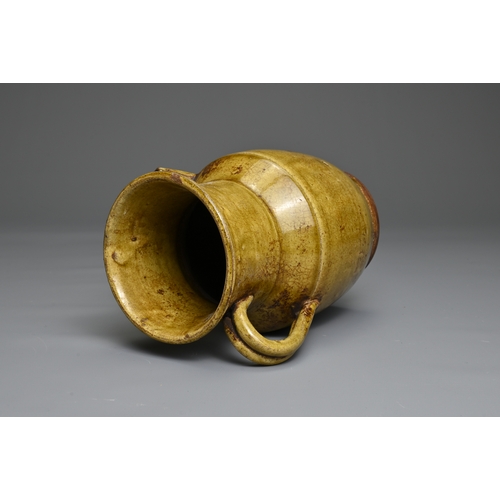 73 - A CHANGSHA TYPE GLAZED STONEWARE EWER COATED IN A FINELY CRACKLED YELLOWISH GREEN GLAZE. Below the s... 