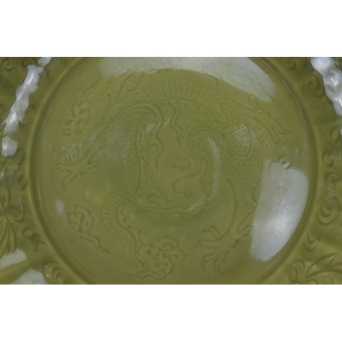 77 - A VERY LARGE CHINESE CELADON PORCELAIN CHARGER. Heavily potted with bracket lobed rim. Decorated wit... 