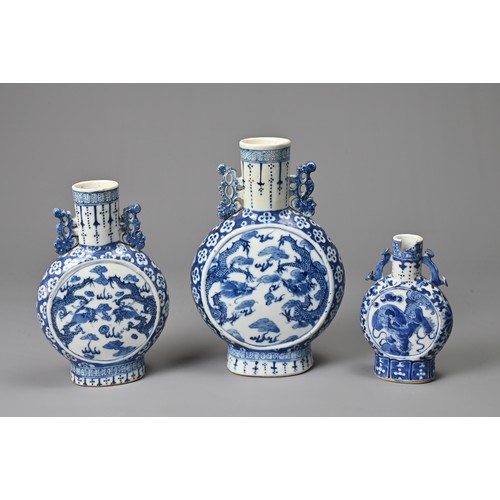 21 - THREE CHINESE BLUE AND WHITE PORCELAIN MOON FLASKS, 19TH CENTURY. Of graduating sizes decorated with... 