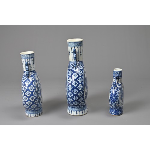 21 - THREE CHINESE BLUE AND WHITE PORCELAIN MOON FLASKS, 19TH CENTURY. Of graduating sizes decorated with... 