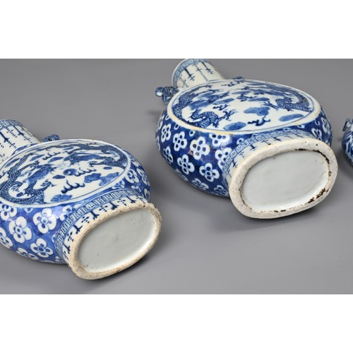 21 - THREE CHINESE BLUE AND WHITE PORCELAIN MOON FLASKS, 19TH CENTURY. Of graduating sizes decorated with... 