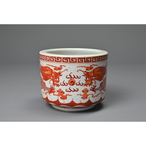 39 - A CHINESE IRON RED DECORATED PORCELAIN POT, GUANGXU MARK. Of cylindrical form decorated with dragons... 