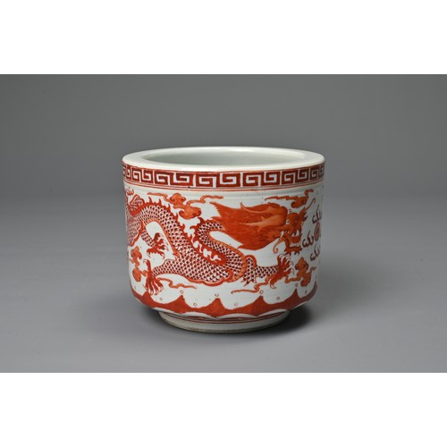 39 - A CHINESE IRON RED DECORATED PORCELAIN POT, GUANGXU MARK. Of cylindrical form decorated with dragons... 