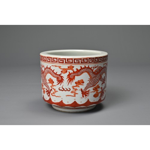 39 - A CHINESE IRON RED DECORATED PORCELAIN POT, GUANGXU MARK. Of cylindrical form decorated with dragons... 